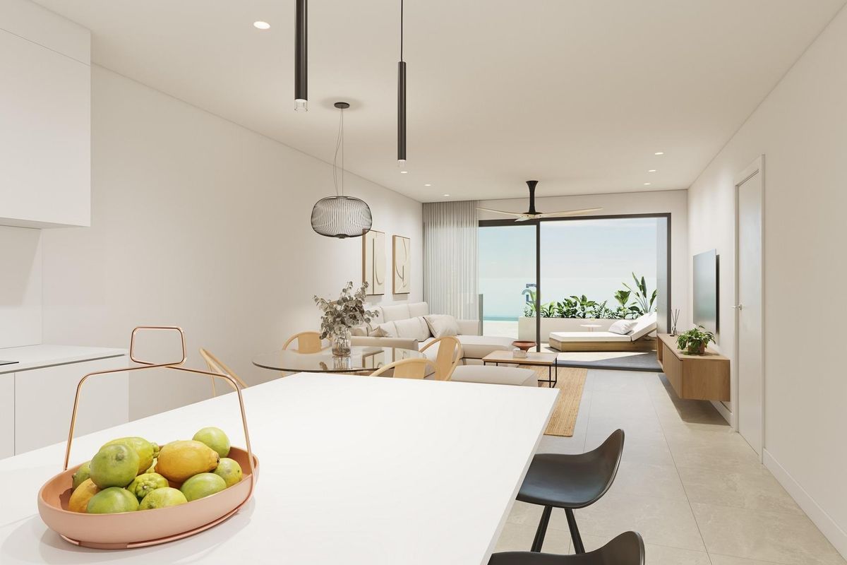 Moderne keukeneiland met een fruitschaal en open indeling, te vinden in een appartement in Pilar de La Horadada.