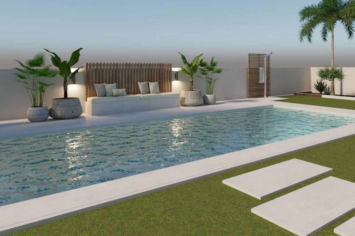 Inviting pool area of a 3-bed villa in Pinoso, featuring lounge seats and lush greenery.