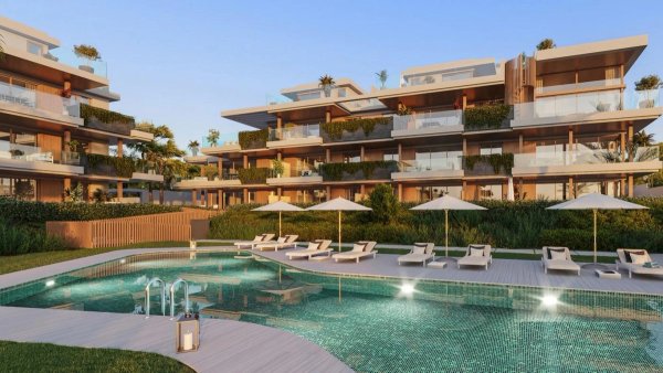 Modern appartementencomplex met een zwembad, omgeven door weelderige tuinen in Estepona, Costa del Sol.