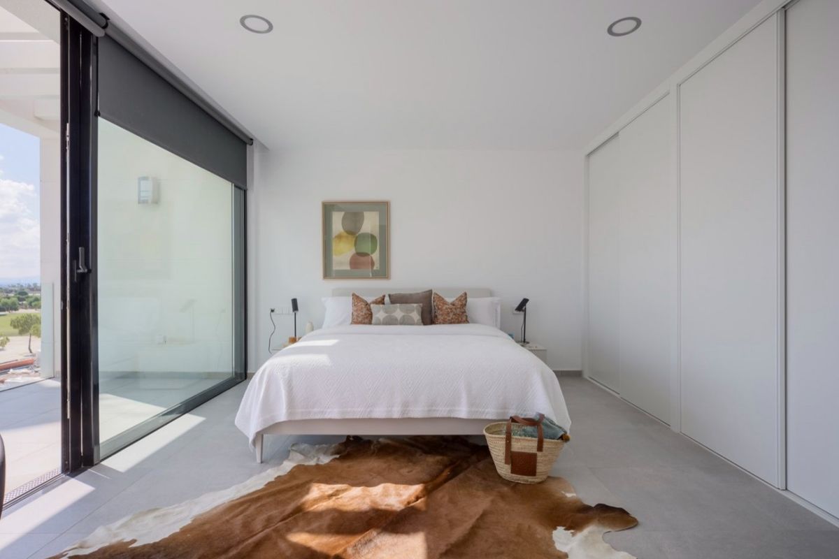 Inviting bedroom with balcony access in the Baños y Mendigo villa, designed for comfort and relaxation.