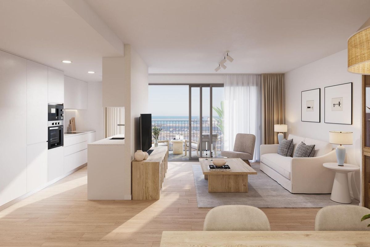 Bright living area in a 2-bed apartment in Alicante, showcasing a cozy sofa and a sea view from the balcony.