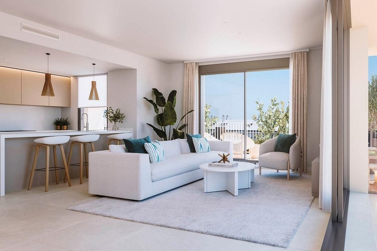 Stylish living room in a ground floor apartment with an open kitchen and large windows in Denia, Costa Blanca North.