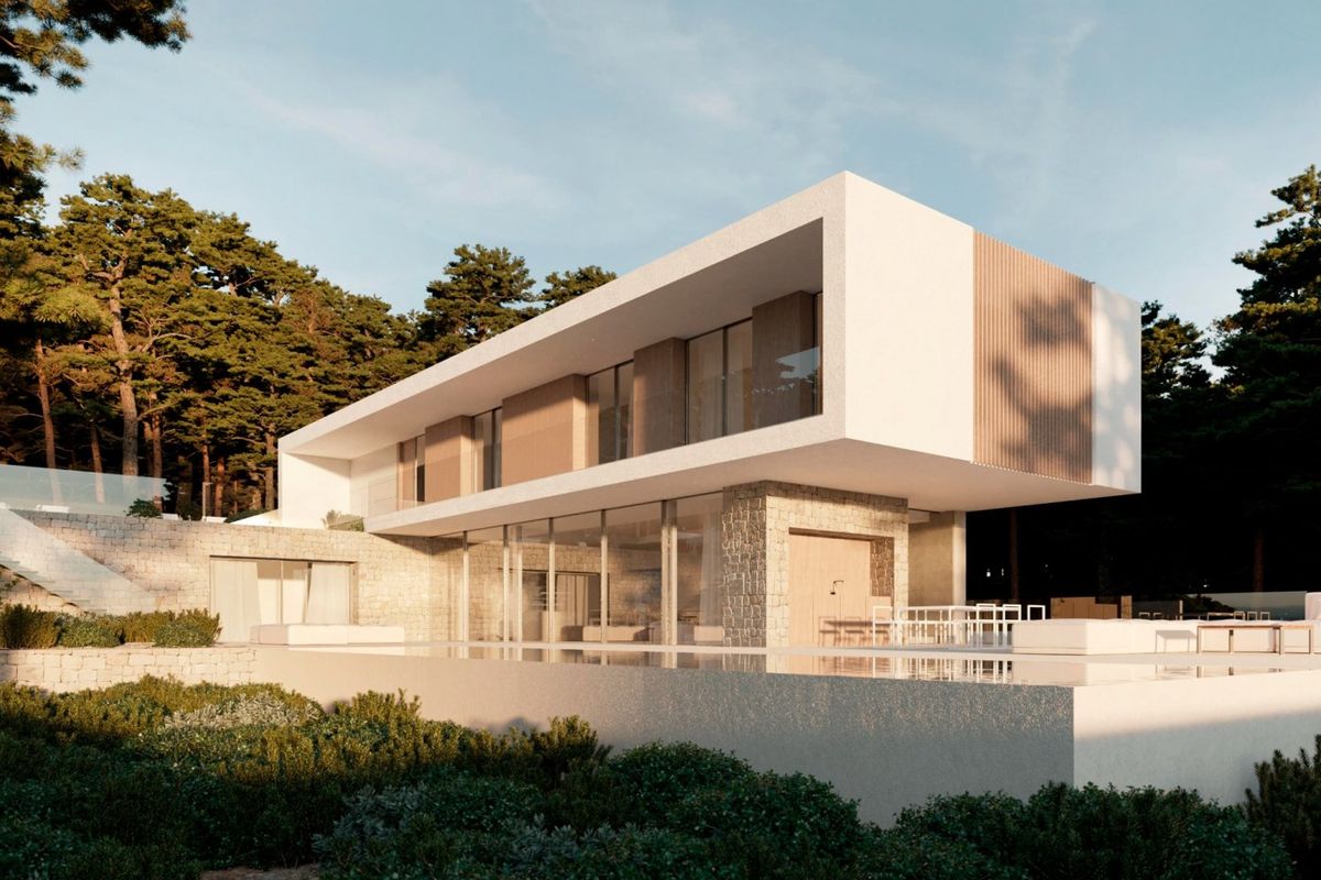 Moderne 4-slaapkamer villa buitenkant in Moraira Teulada, omringd door groen en een stenen terras.