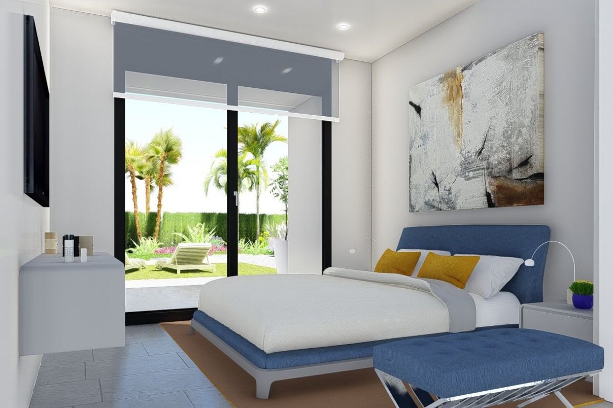 Brightly decorated bedroom in a 2-bed villa in Calasparra, showcasing a view of the garden.