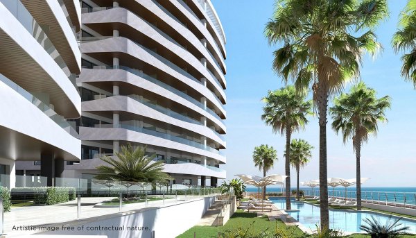 Exterior view of modern apartment building with palm trees, pool, and sea in La Manga del Mar Menor.
