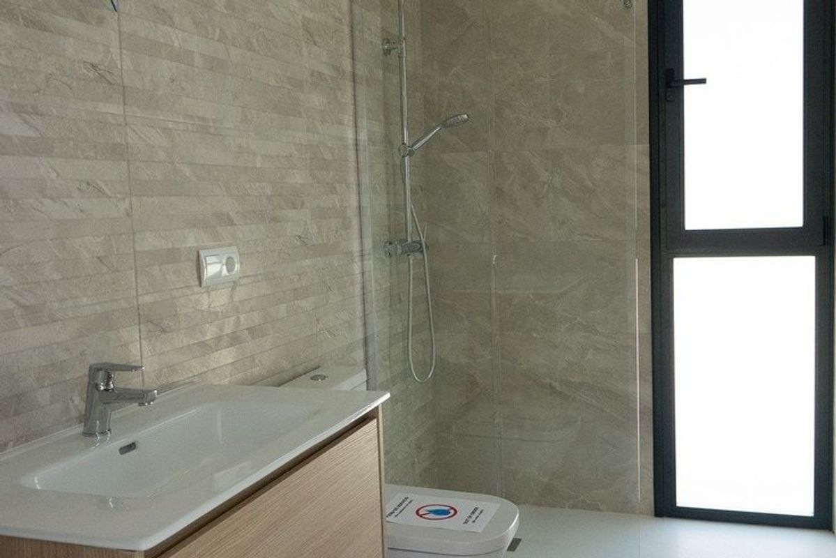 Modern badkamer met een stijlvolle douche en wastafel in een villa in Polop.