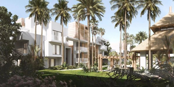 Buitenzicht op een modern 2-slaapkamer appartementcomplex omringd door palmbomen in Estepona, Costa del Sol.