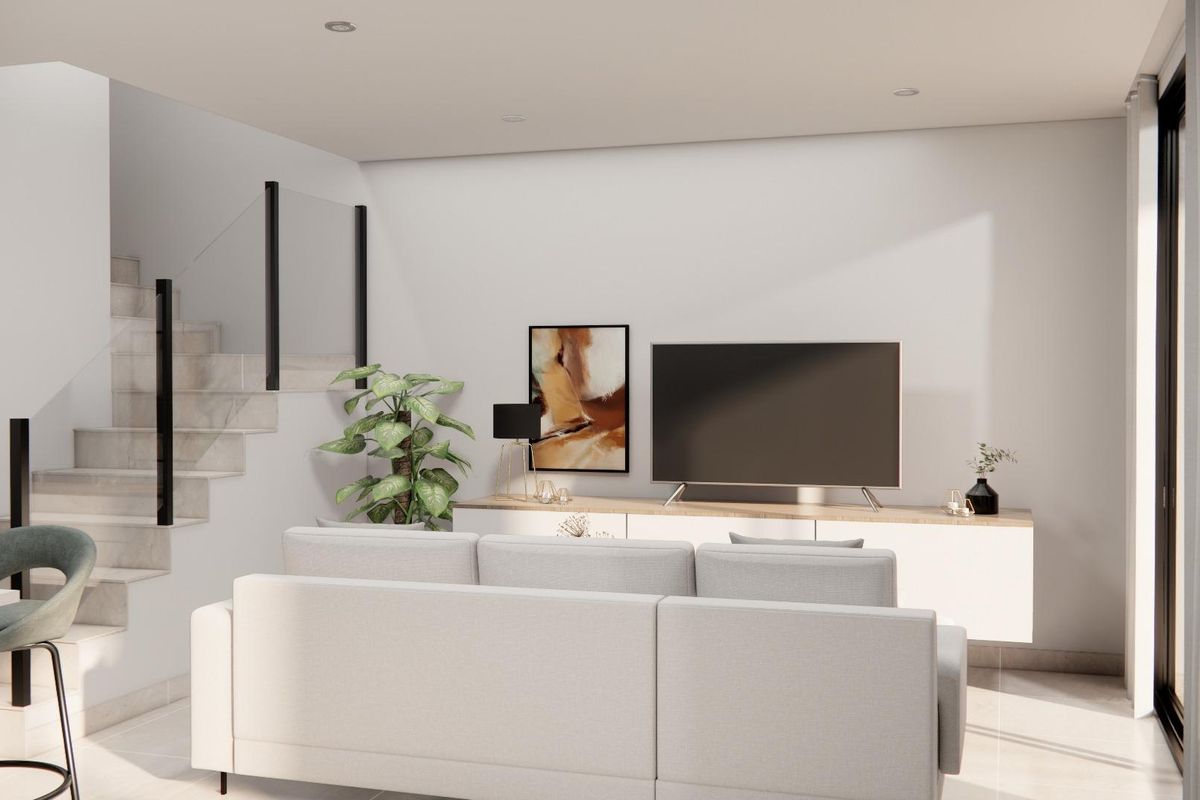 Woonkamer in de townhouse in Rojales, met moderne meubels en een vleugje groen.