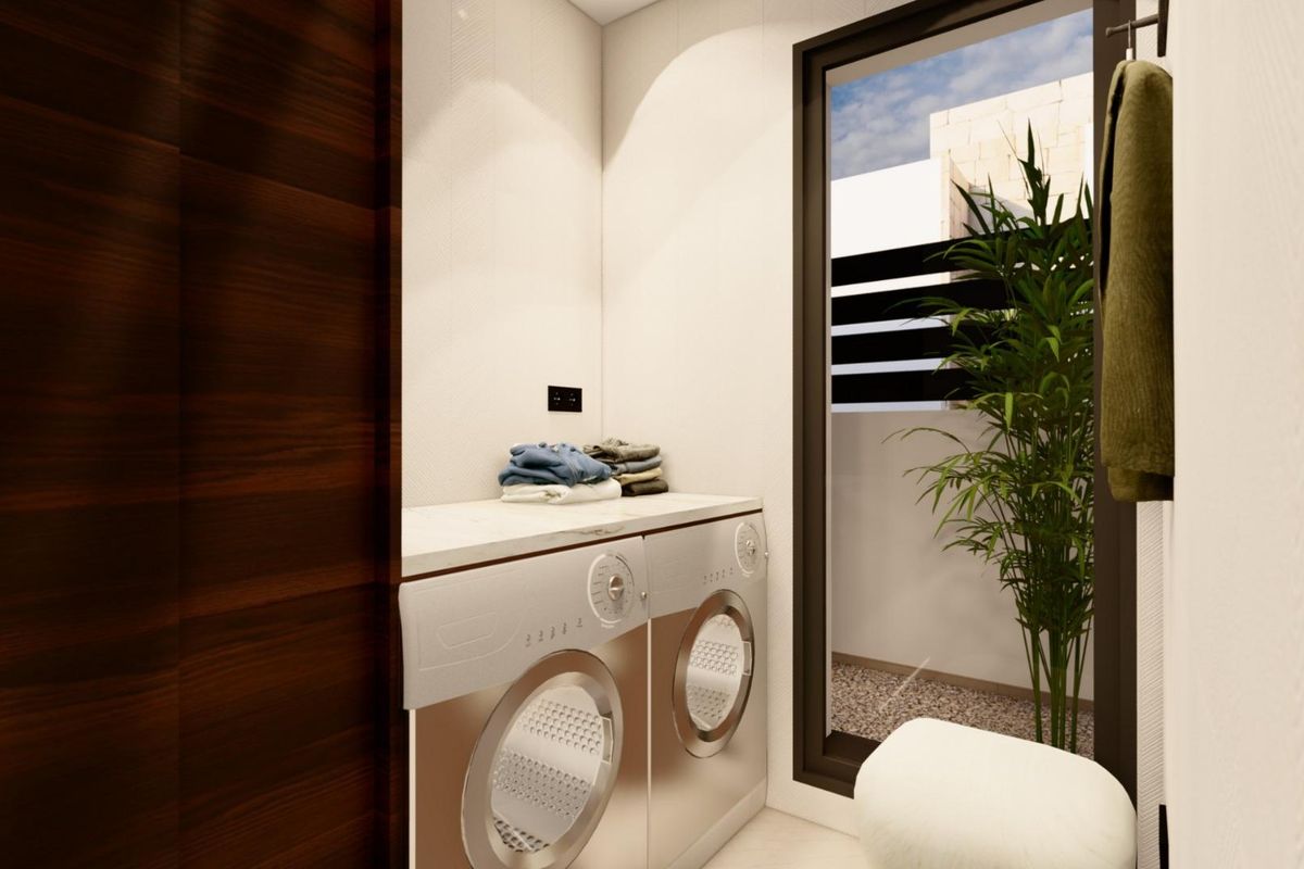 Waskamer met wasmachines en veel natuurlijk licht in een villa in Benijofar.