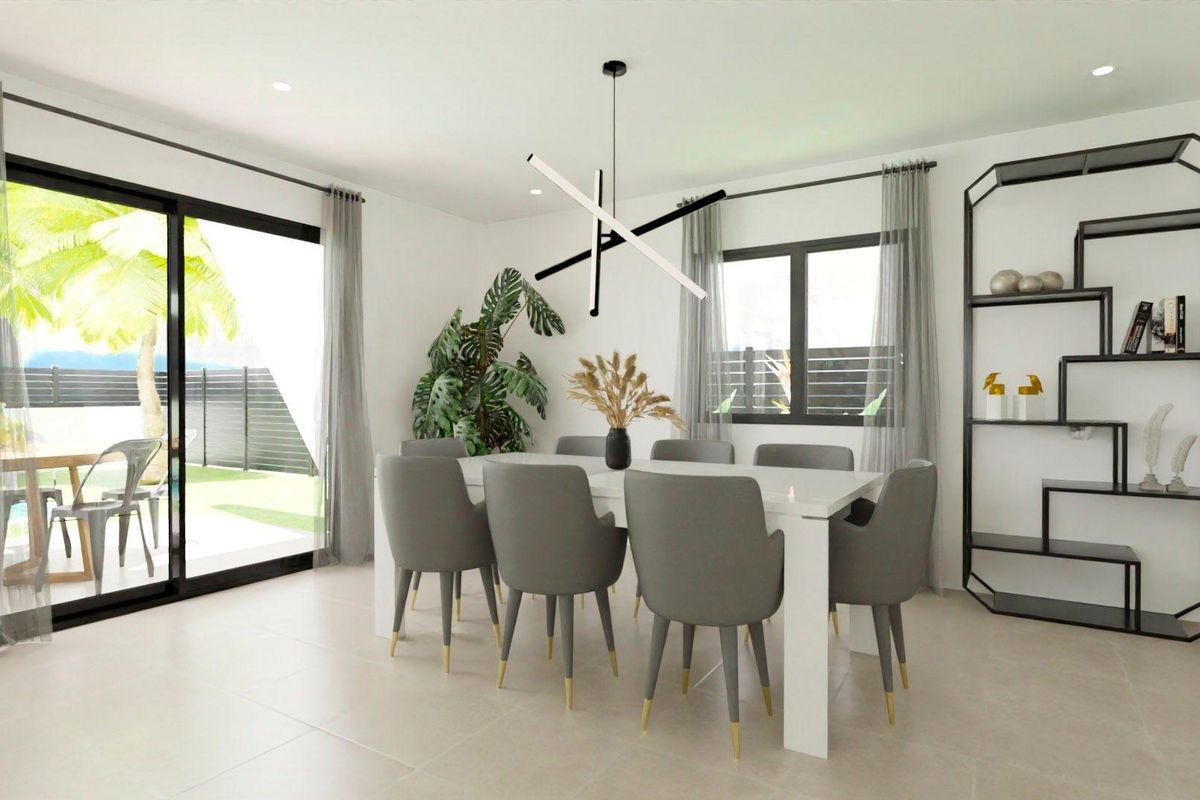 Elegant dining area in a 3-bed villa with modern decor and a view of the garden in Monforte del Cid.