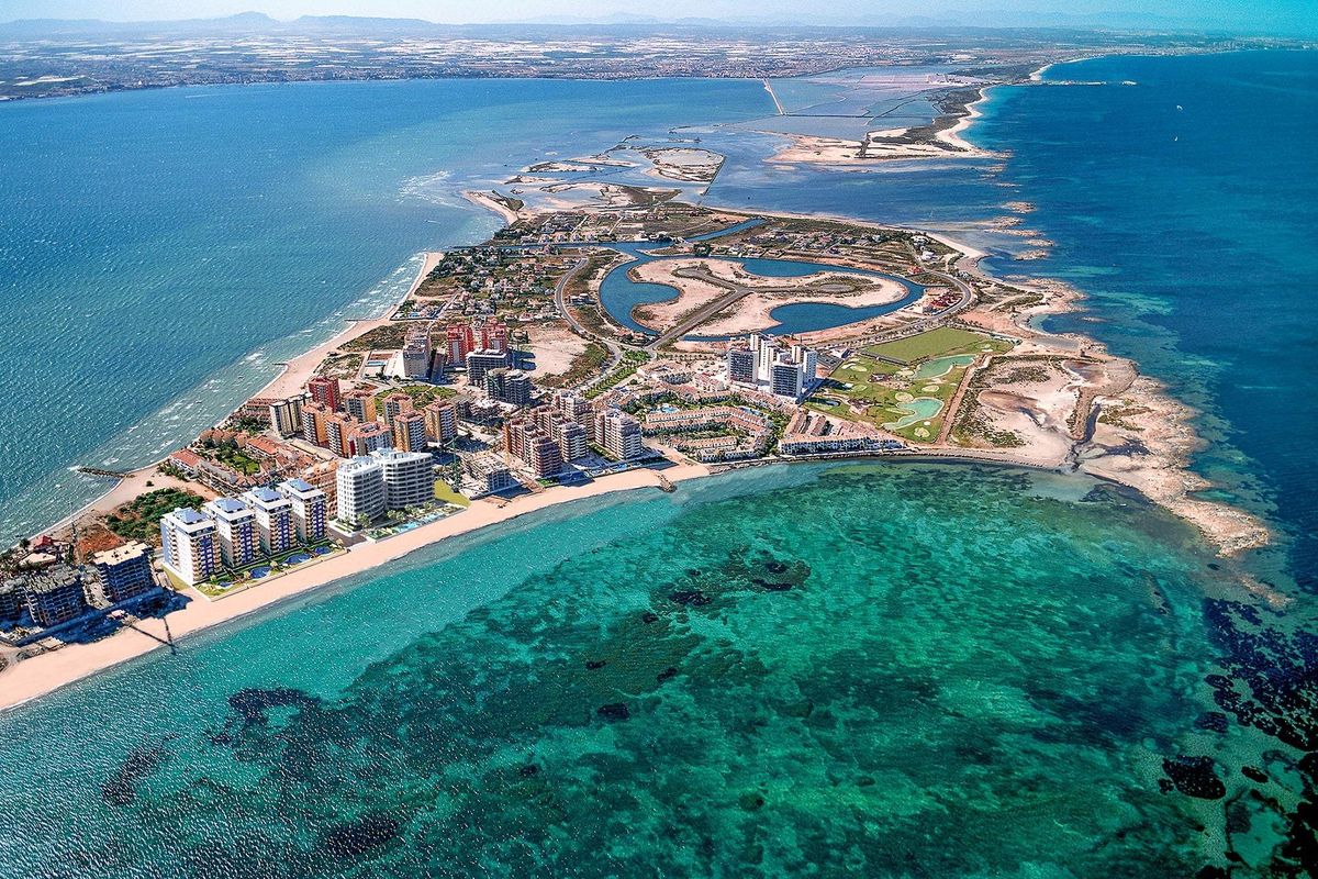 Aerial view of La Manga del Mar Menor showcasing coastal properties and vibrant blue waters.