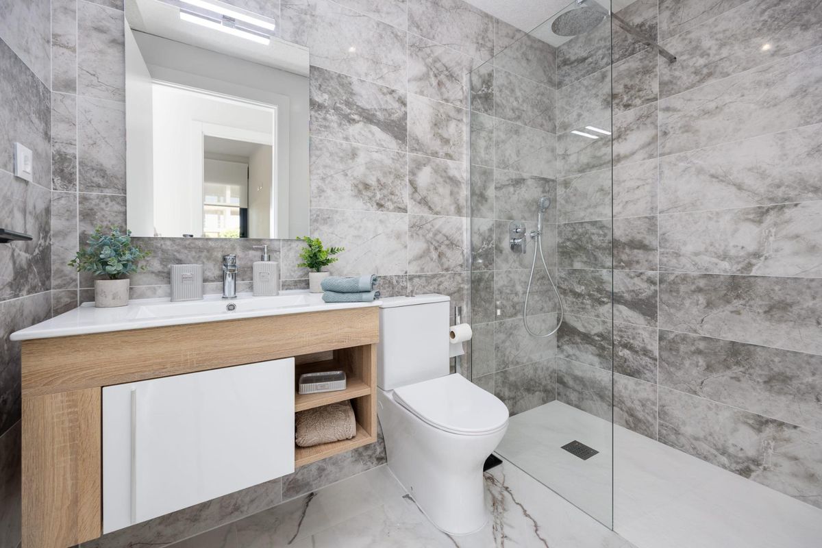 Stijlvolle badkamer in een 2-slaapkamer appartement met moderne armaturen en grijze marmeren tegels in San Miguel de Salinas.