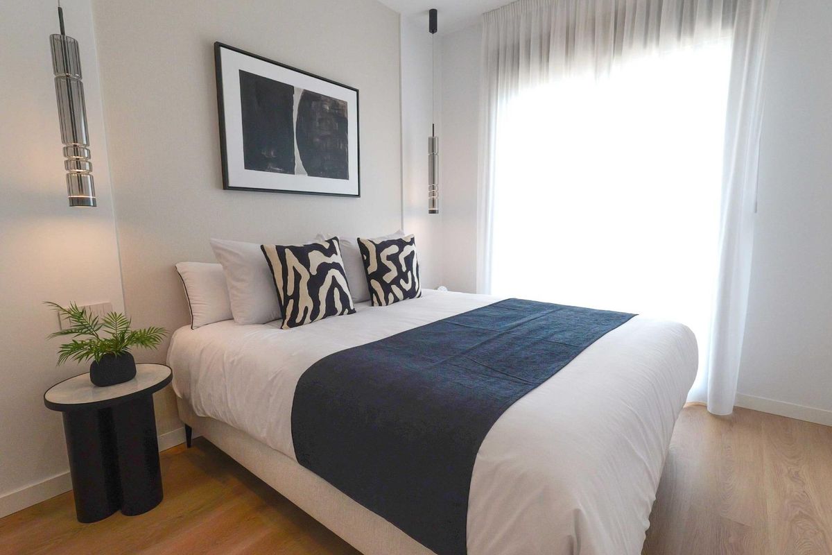 Chic bedroom featuring plush bedding and modern decor in a 2-bed apartment, La Manga del Mar Menor.