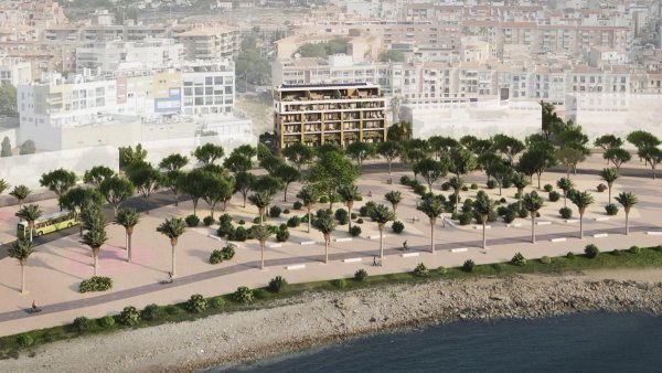 Aerial view of a modern residential complex in Villajoyosa with pathways and greenery along the coast.