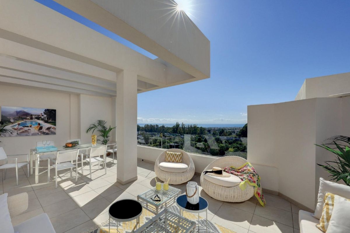 Ruimtelijk terras met buitenzitplaatsen en panoramisch uitzicht in een 2-slaapkamer appartement in Marbella.