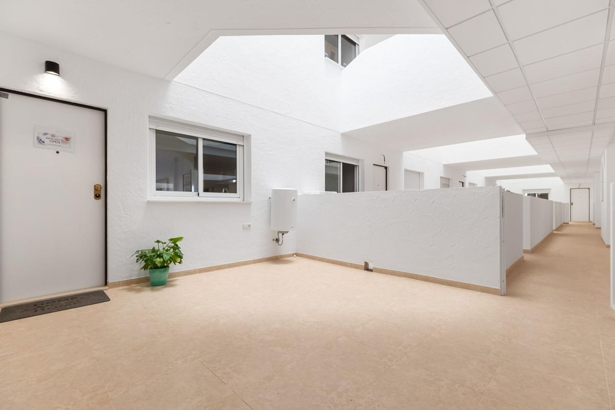 Heldere gang binnen het appartementencomplex in Orihuela Costa met natuurlijk licht.