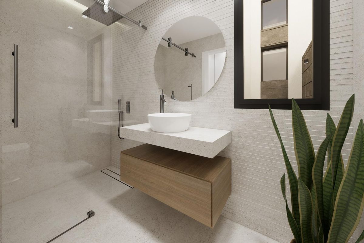 Moderne badkamer met een strakke afwerking en een ronde spiegel, gelegen in een stijlvol 3-slaapkamer huis in Dolores.