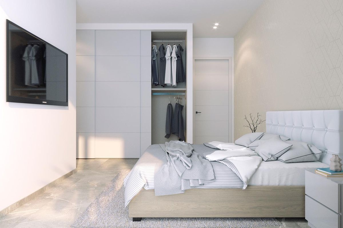 Gezellige slaapkamer met modern ontwerp en voldoende opbergruimte in een 2-slaapkamer appartement in Torrevieja, Spanje.