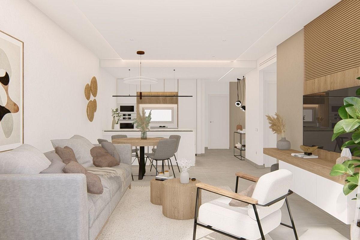 Bright and inviting open-plan living and kitchen area in the apartment, designed for comfort and functionality.