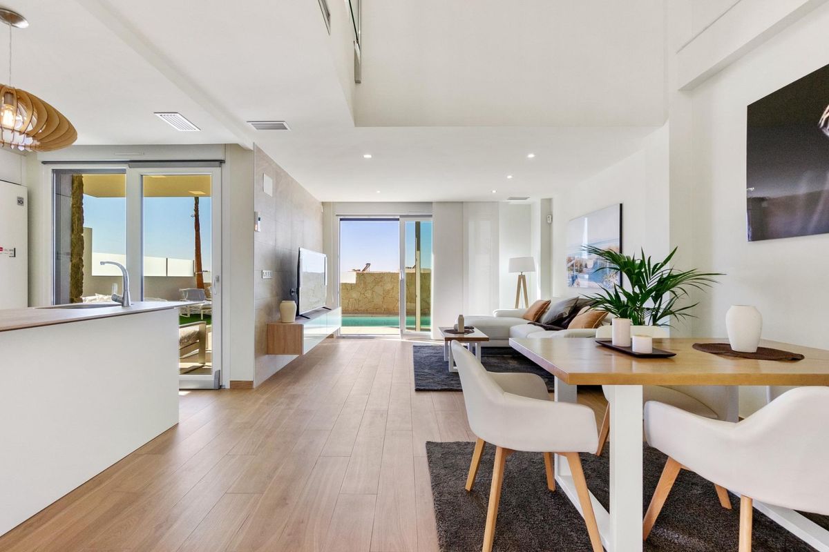 Heldere eetruimte met uitzicht op het zwembad, onderdeel van een moderne leefruimte in villa Rojales.