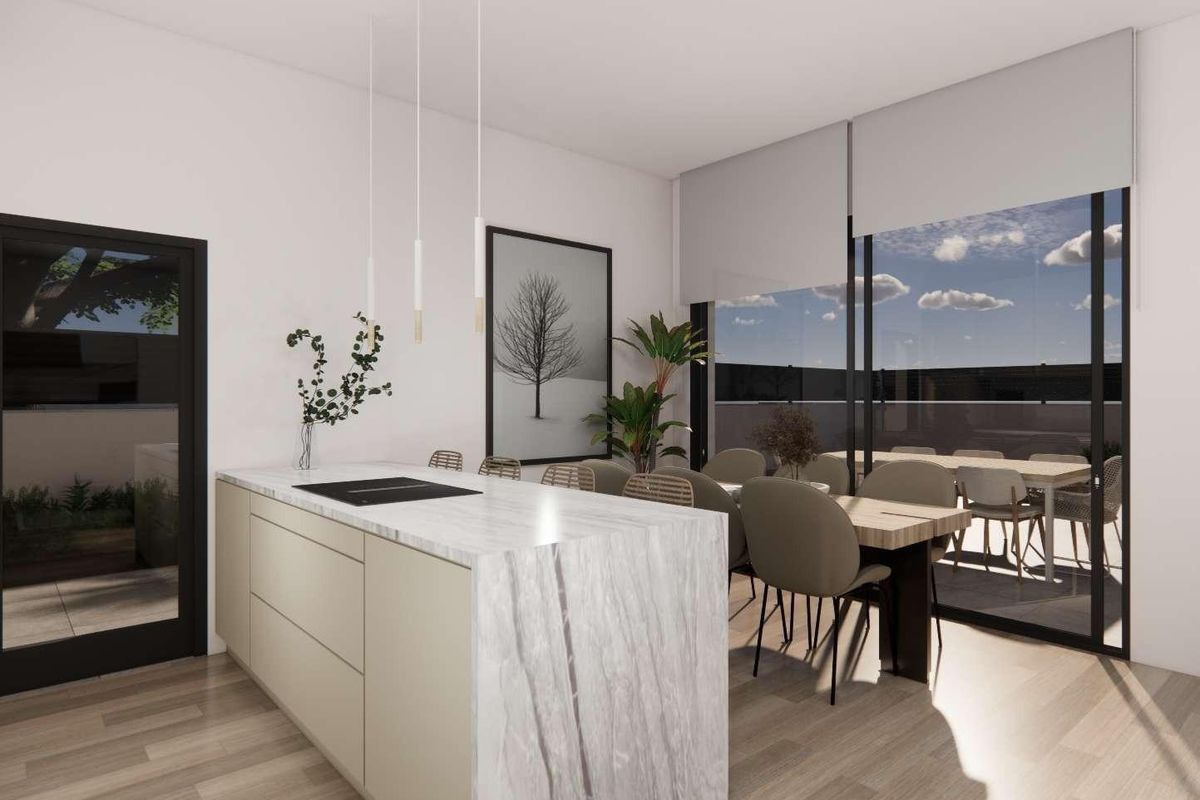 Stylish keuken in een 3-slaapkamer villa in Rojales, belicht door natuurlijk licht en een moderne eettafel.