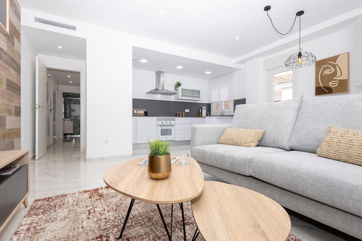 Gezellige woonkamer in het 2-slaapkamer appartement van Jacarilla, met uitzicht op de keuken.