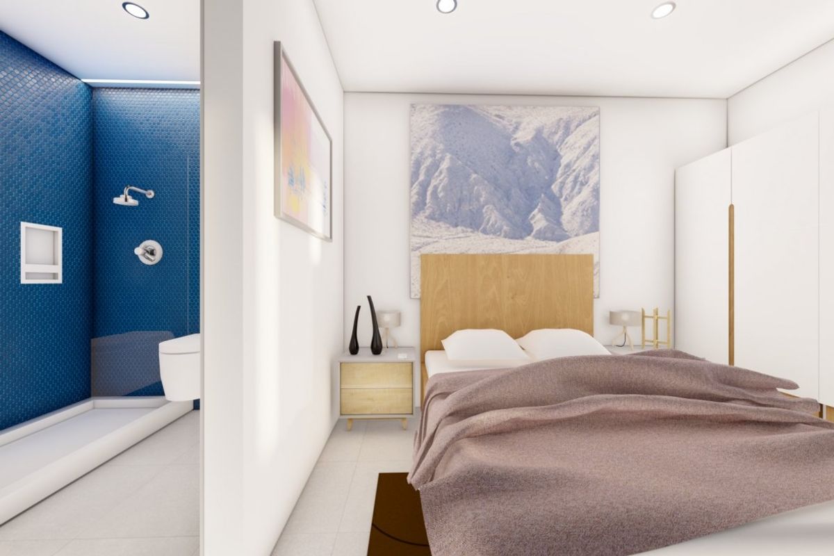 Moderne slaapkamer met strakke meubels en aangrenzende badkamer in de 3-slaapkamer villa in Los Urrutias.