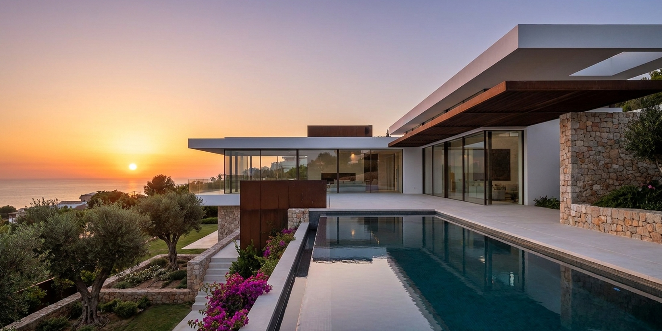 A modern new build family villa in Spain featuring a sleek white exterior, large glass windows, and a private infinity pool at sunset.