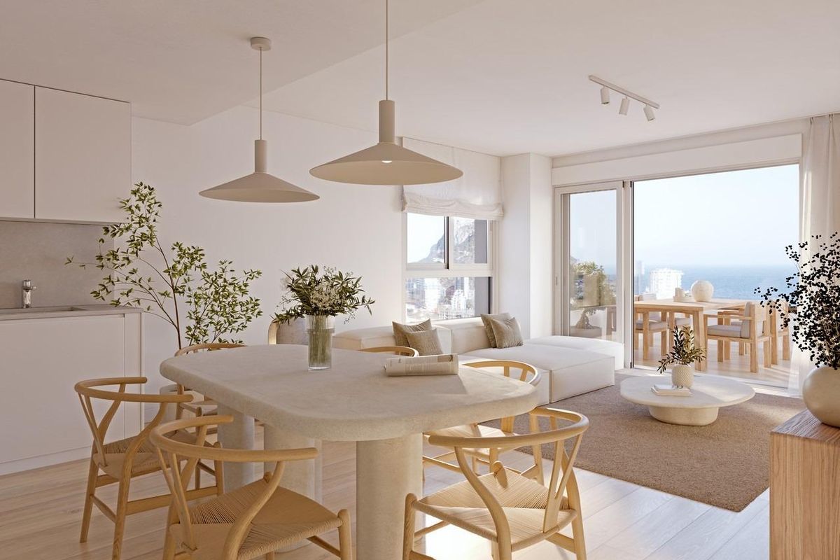 Minimalist dining table with a coastal view in the background, perfect for serene dining experiences in Calpe.