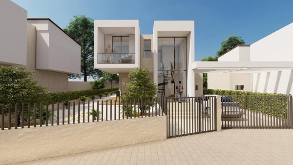 Moderne 3-slaapkamer villa exterieur in La Nucia, Costa Blanca, omgeven door groen en een hekje.