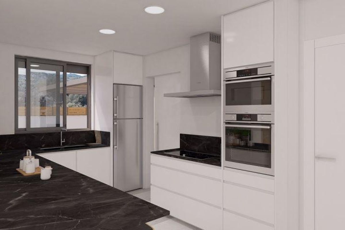 Strakke keukenontwerp in een moderne villa in Aspe, uitgerust met high-end apparaten en open ruimte.