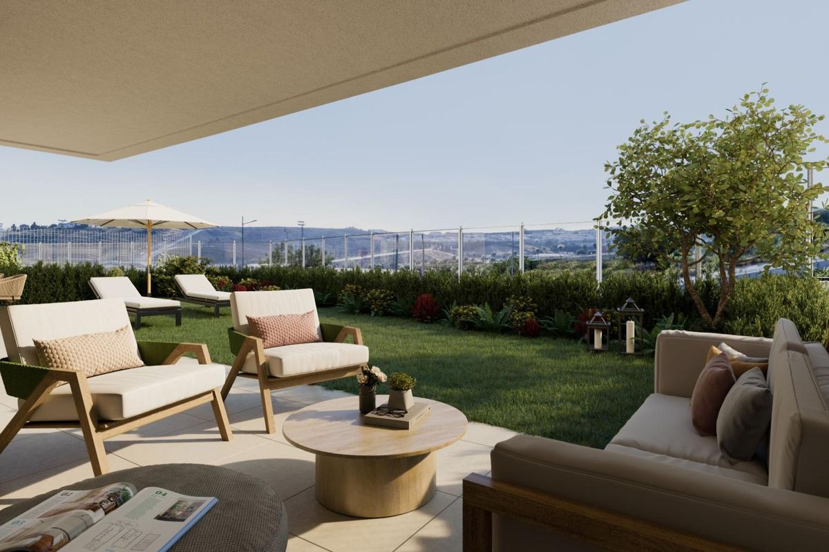 Patio van de benedenwoning met een tuin en zitgedeelte, gelegen in Estepona, Costa del Sol.