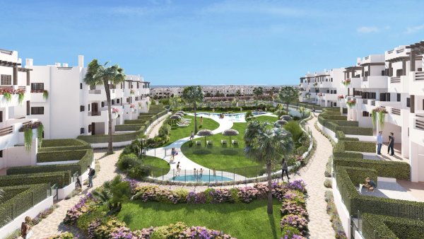 Luchtfoto van een modern wit appartementencomplex met zwembad en weelderige aangelegde tuinen in Mar de Pulpi, Spanje