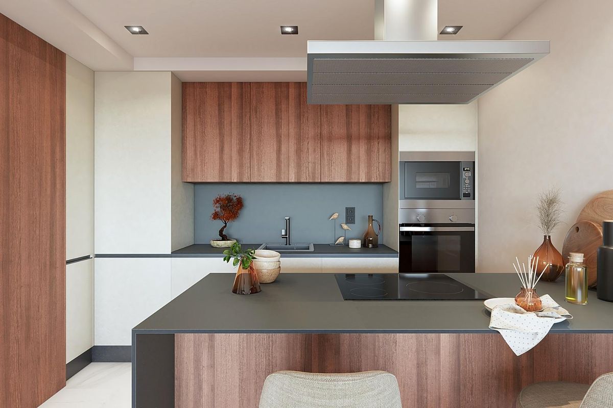 Moderne keukenopstelling in een appartement in Marbella met slanke kasten en hoogwaardige apparaten.