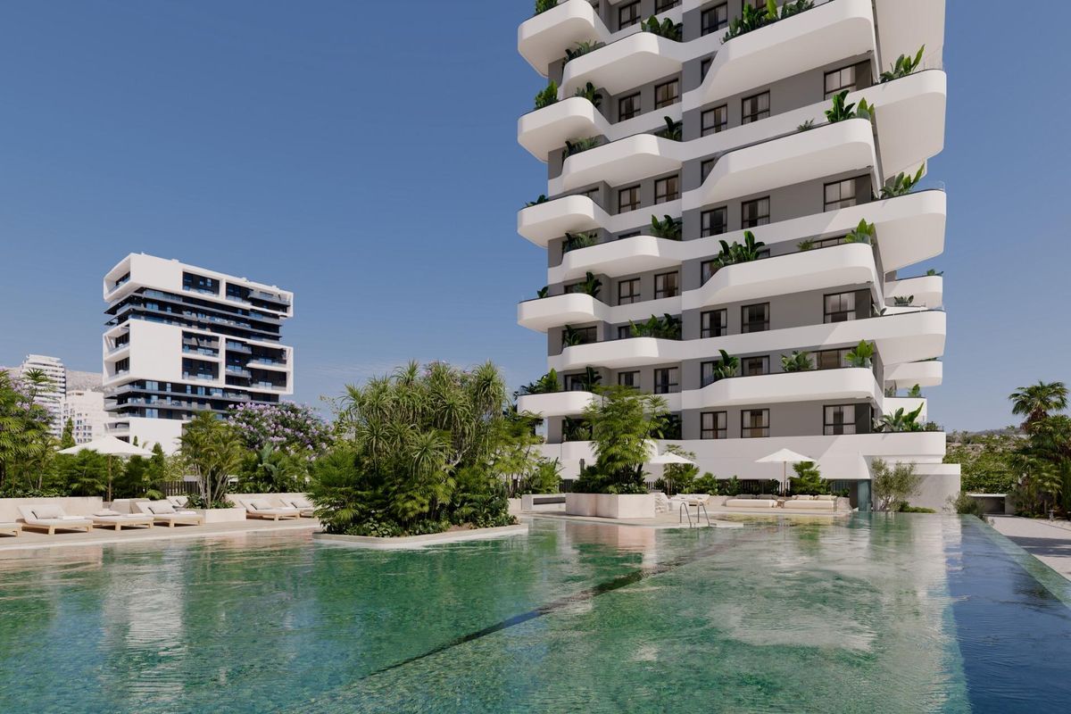 Beautiful pool surrounded by greenery at a modern apartment complex in Calpe, Costa Blanca North.