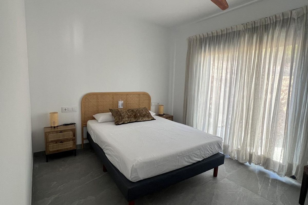 Gezellige slaapkamer in een townhouse in Polop, met natuurlijk licht en eenvoudige decoratie in Costa Blanca Noord.