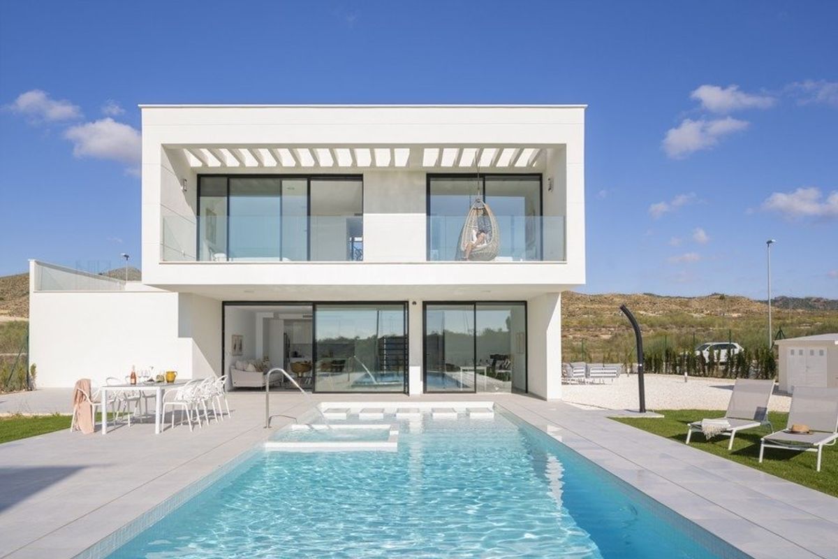 Stylish modern villa with a large pool and outdoor seating, set in Baños y Mendigo, Spain.
