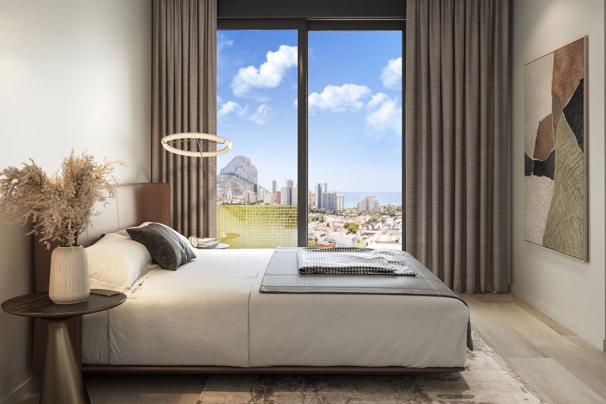 Gezellige slaapkamer in een appartement in Calpe, ontworpen voor comfort met uitzicht op de kust.