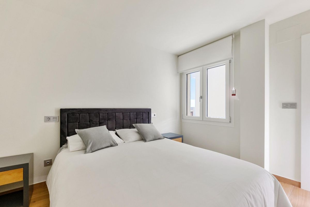 Elegante slaapkamer met een groot bed en daglicht, onderdeel van de 3-slaapkamer villa in Rojales.