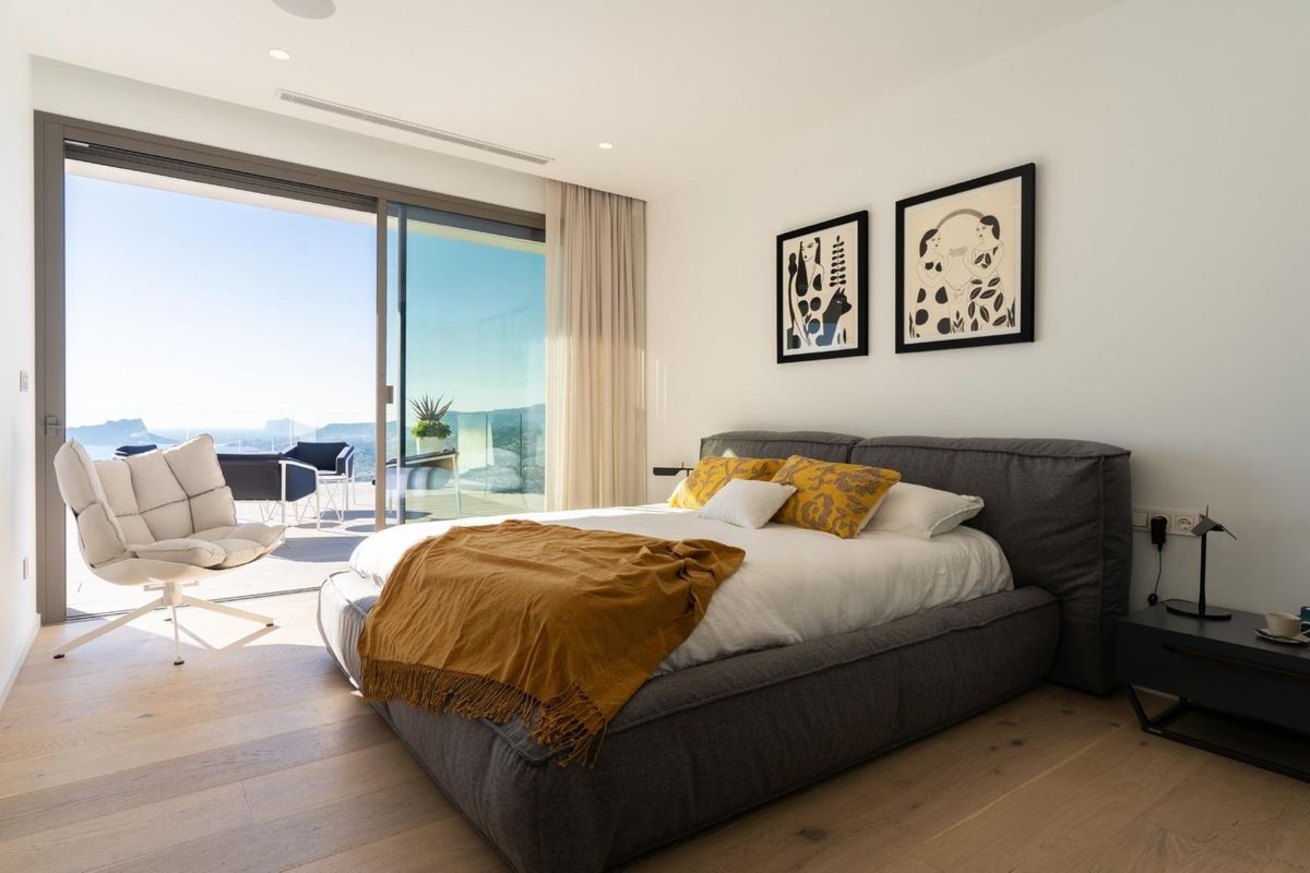 Contemporary bedroom in a villa located in Benitachell, Costa Blanca, with stylish furniture and views.