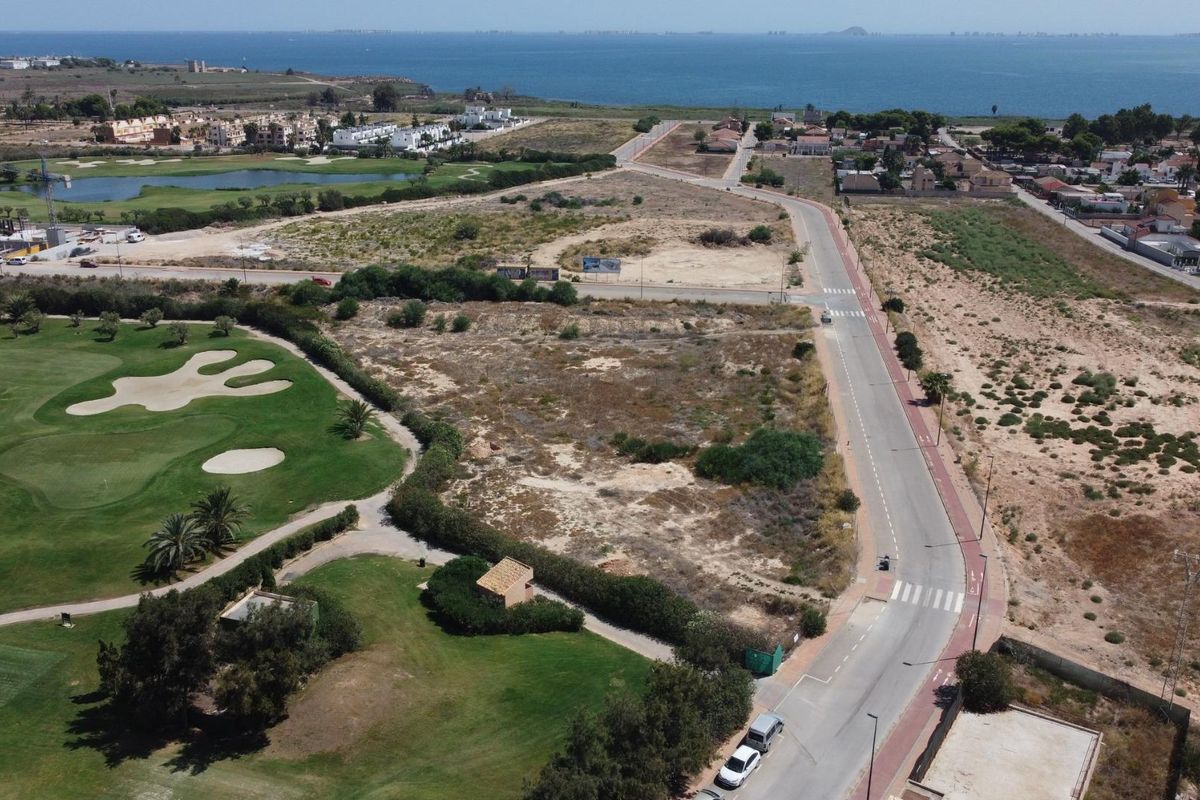 Aerial view of golf course and coastal development plots in Los Alcazares, Costa Calida, Spain. Showing road and surrounding area.