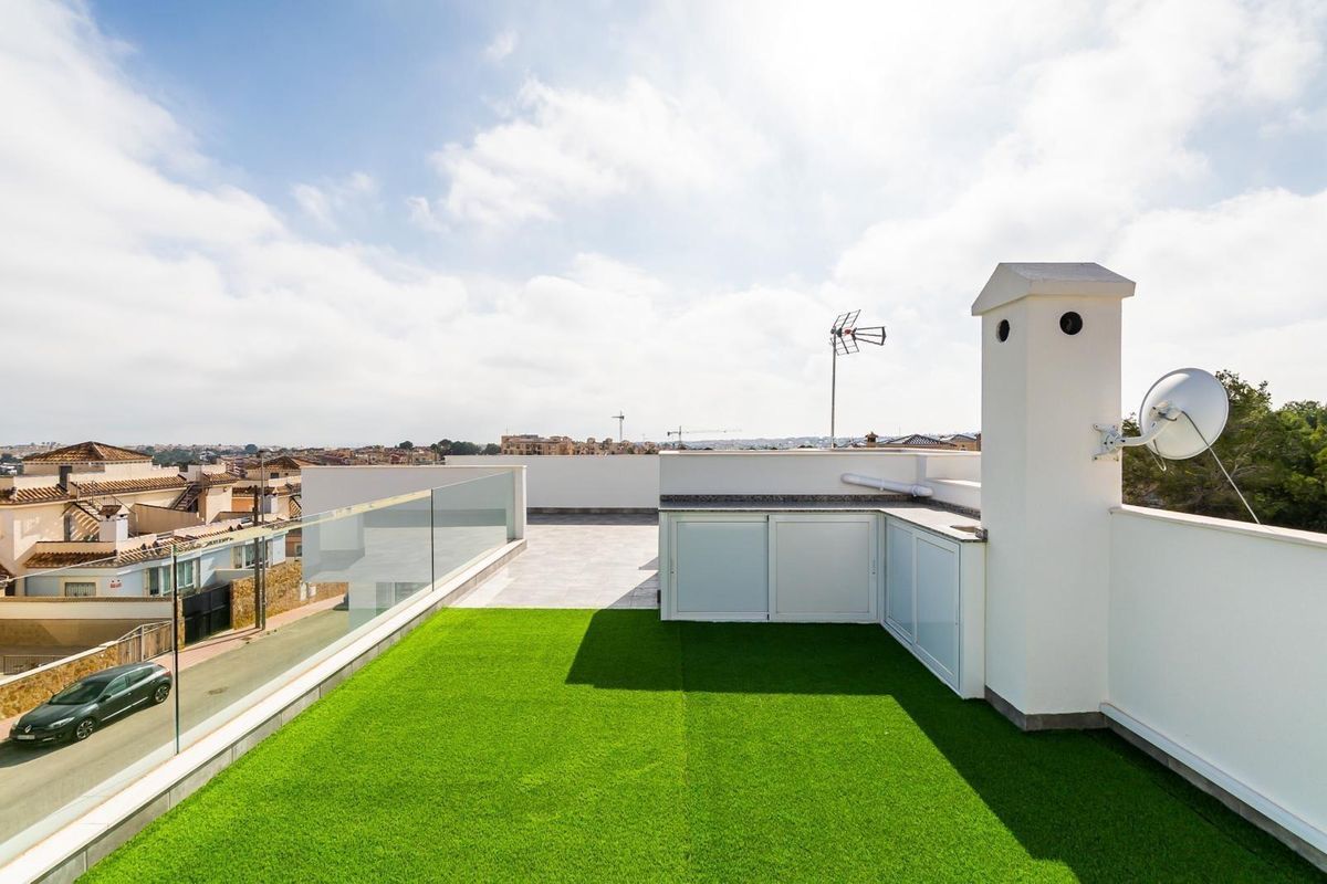 Spacious rooftop terrace at a three-bedroom villa in Orihuela Costa, with green views and ample sunlight.