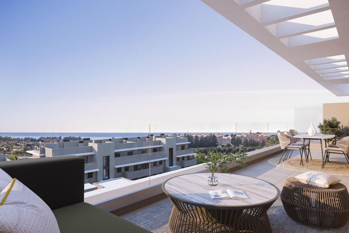 Stijlvol terras met eetgedeelte dat uitkijkt over de zee in het luxe penthouse van Estepona.