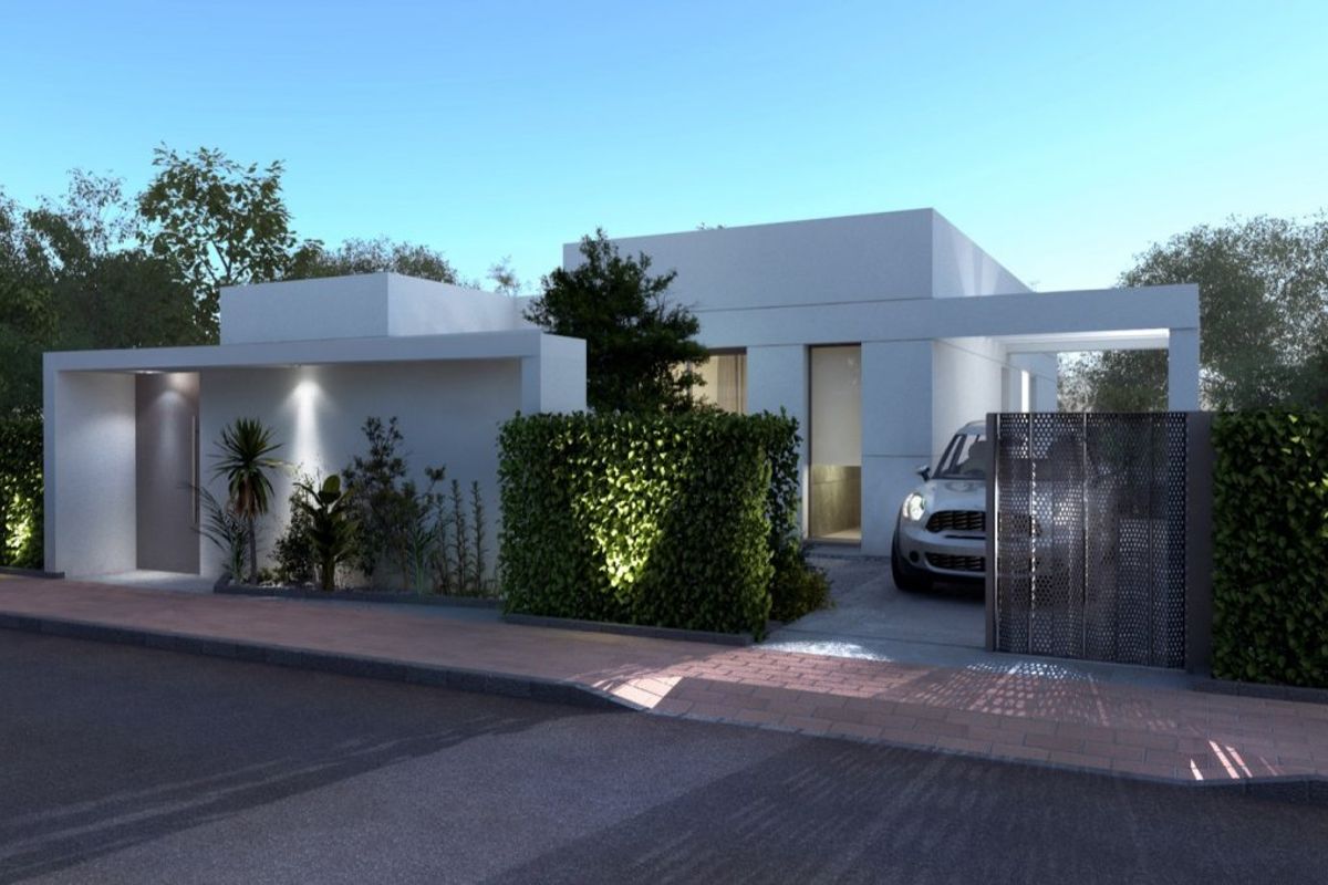 Evening view of a modern villa in Baños y Mendigo, highlighting its beautiful entrance and elegant garden.