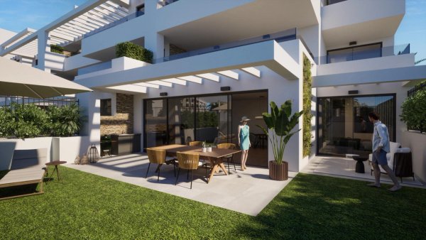 Terras van een 3-slaapkamer appartement op de begane grond in Estepona met eethoek en moderne architectuur.
