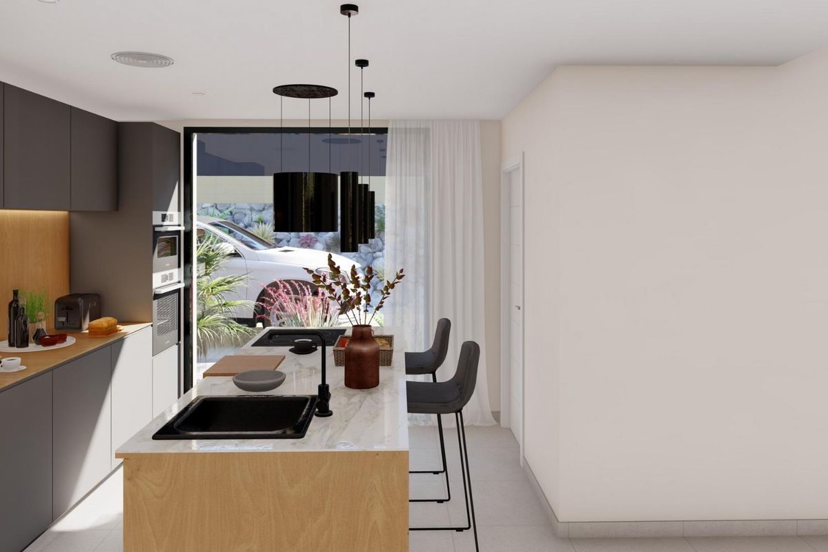 Contemporary keuken met moderne apparatuur en ontbijtbar in deze villa in Baños y Mendigo.