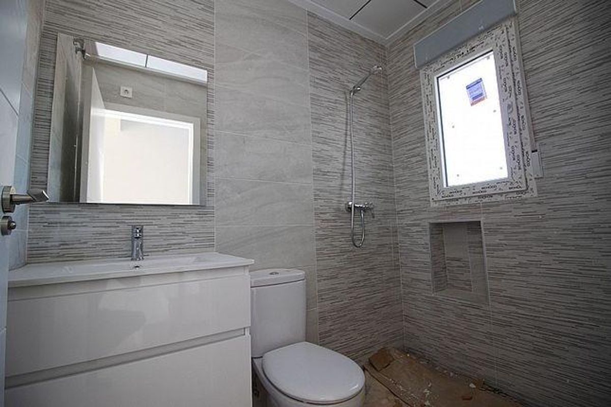 Contemporary badkamer met moderne armaturen en een raam voor natuurlijk licht, gelegen aan de Costa Blanca Zuid.