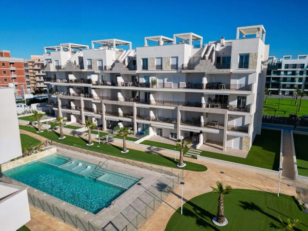 Exterior view of a modern apartment complex with a pool in Guardamar del Segura, Costa Blanca South.