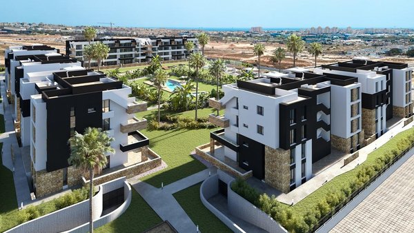 Aanzicht van een nieuw appartementencomplex met groene gebieden en zwembad in Torrevieja, Costa Blanca.