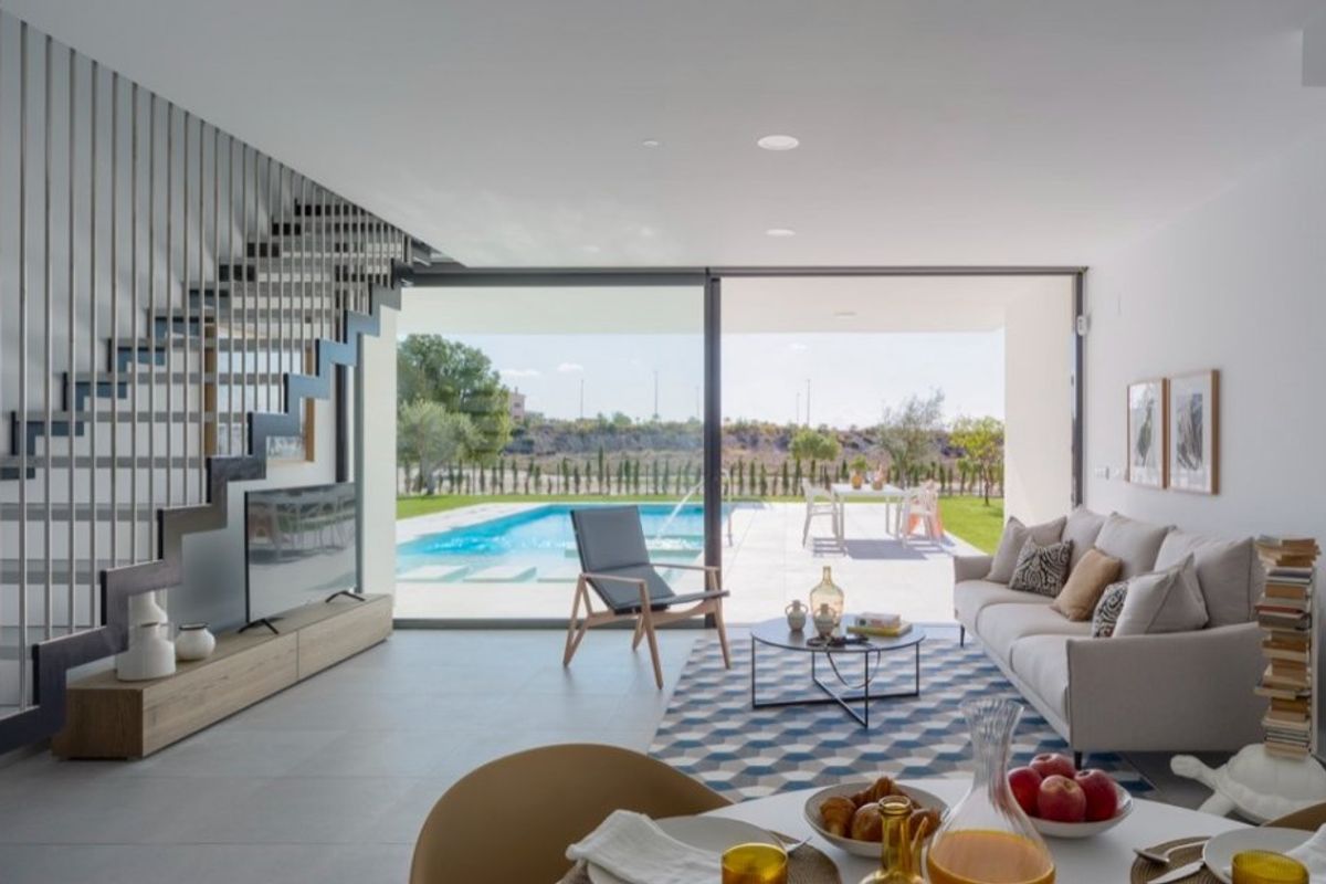 Stylish living area in the villa, showcasing elegant furniture and views of the pool in Baños y Mendigo.
